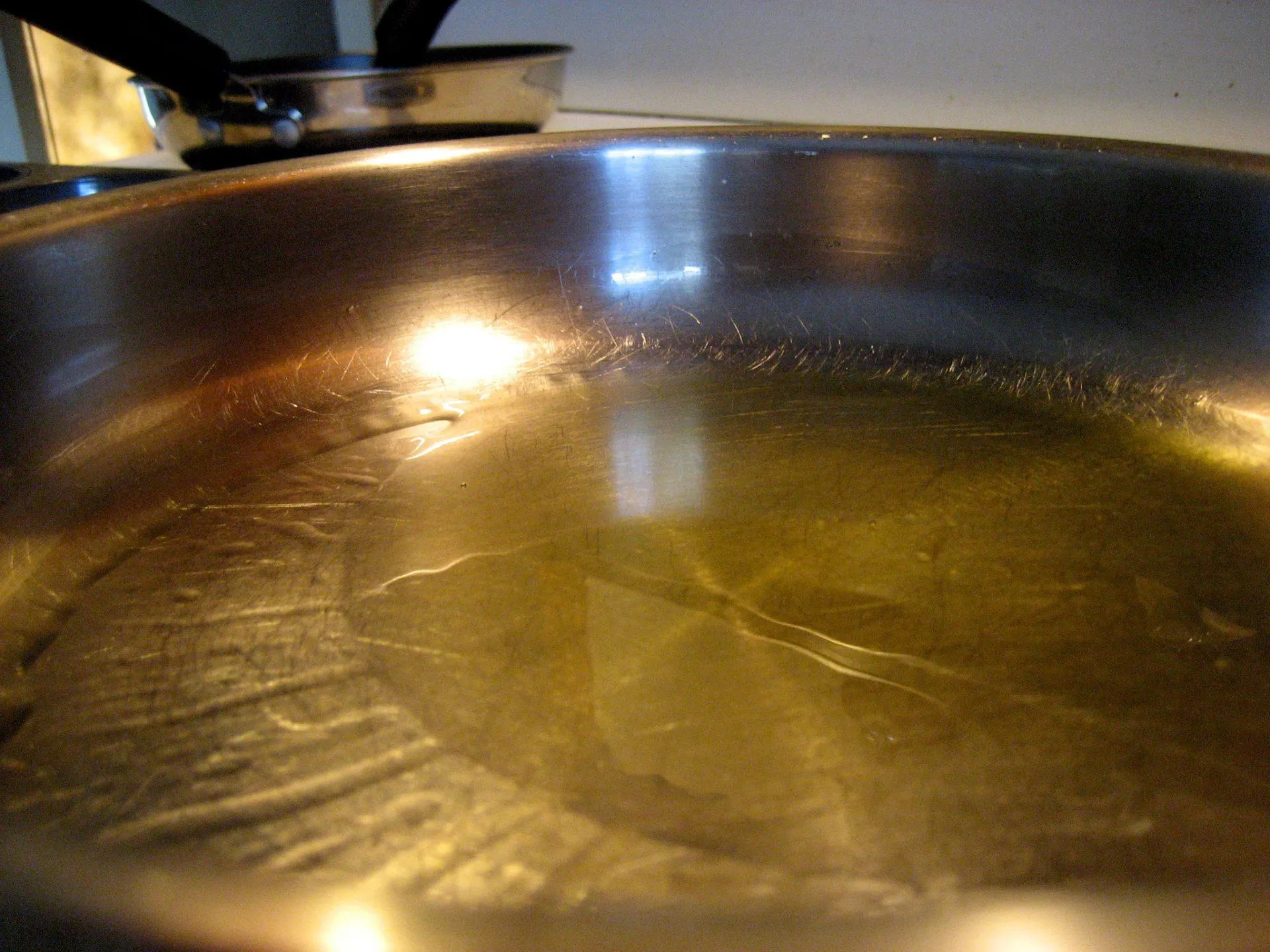Oil coating the bottom of a stainless steel pan