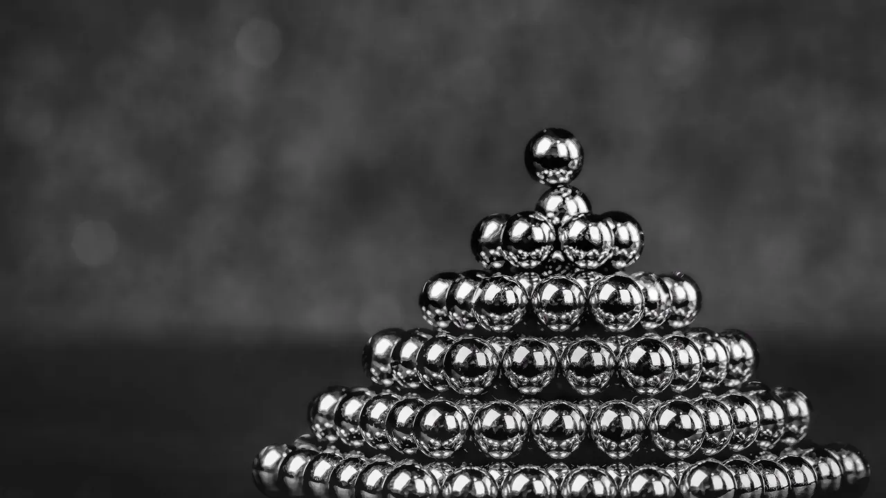Shiny magnetic steel balls stacked in a pyramid