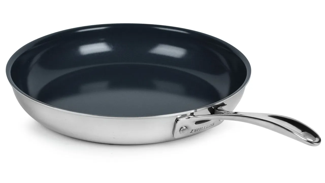 A ceramic-coated stainless steel frying pan on a white background