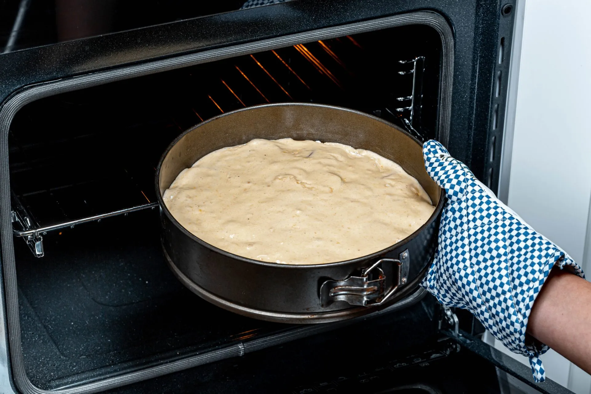 Removing a hot stainless steel pan from the oven