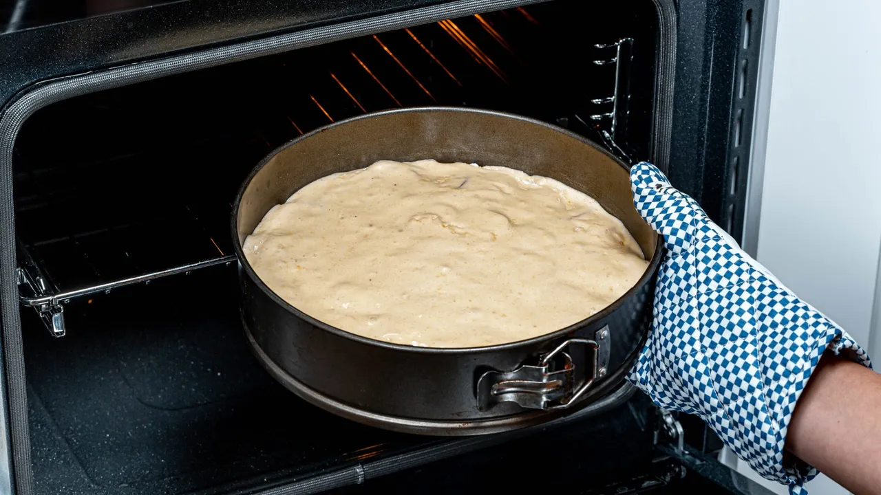 A stainless steel frying pan resting inside a hot oven