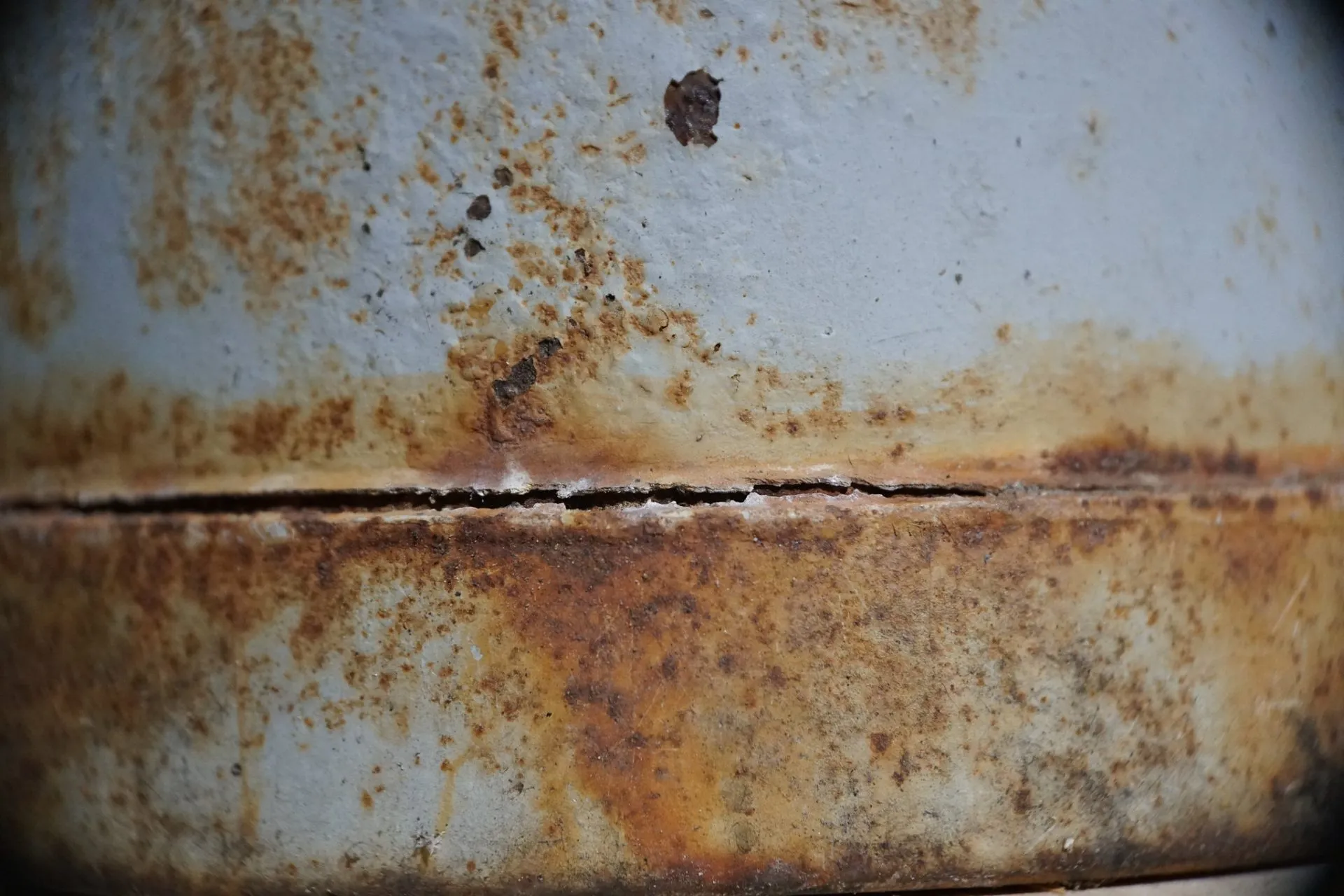 Crevice corrosion forming in a tight gap on a metal fitting