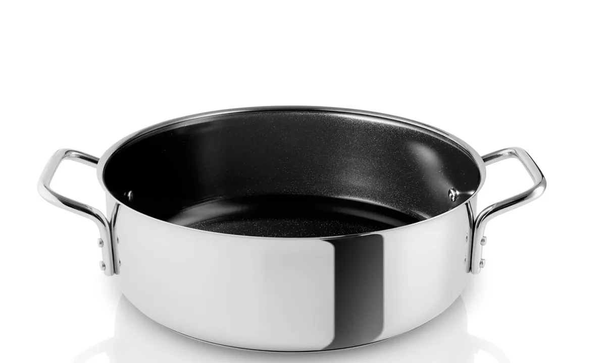 A stainless steel vessel with a dark ceramic-coated interior