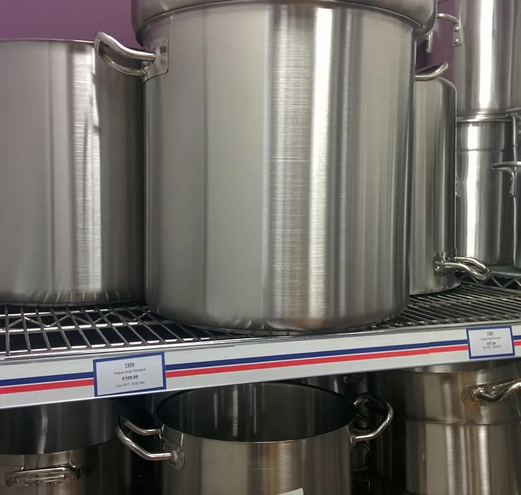 Stainless steel stockpots displayed on store shelving