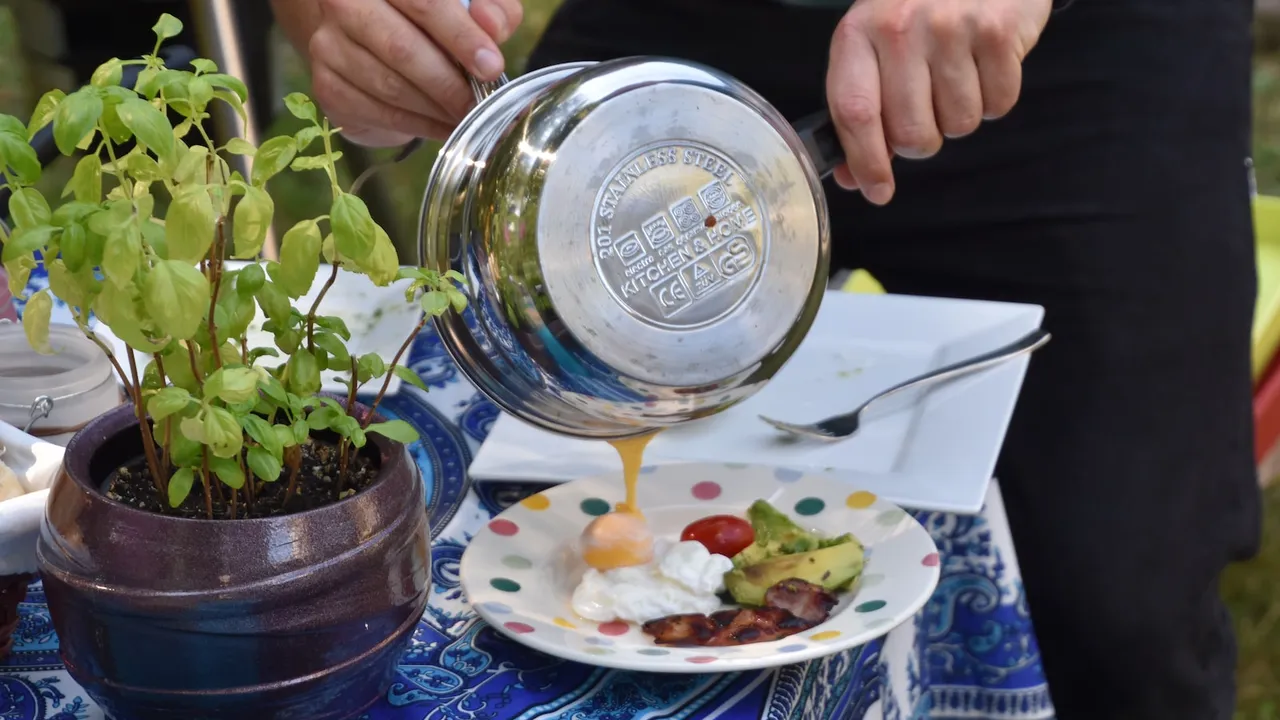 Sauce poured from the base of a stainless steel saucepan onto a plate